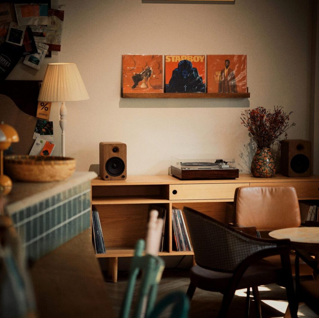Warm, inviting interior featuring a vintage record player, vinyl records, and cozy seating.