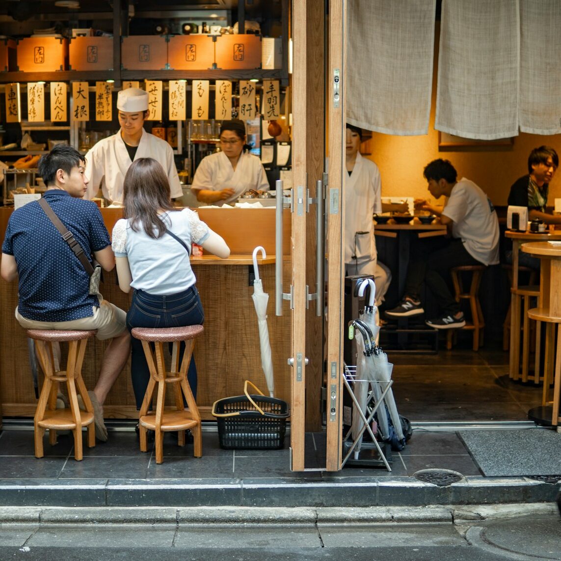 A group of people sitting at a table in a restaurant