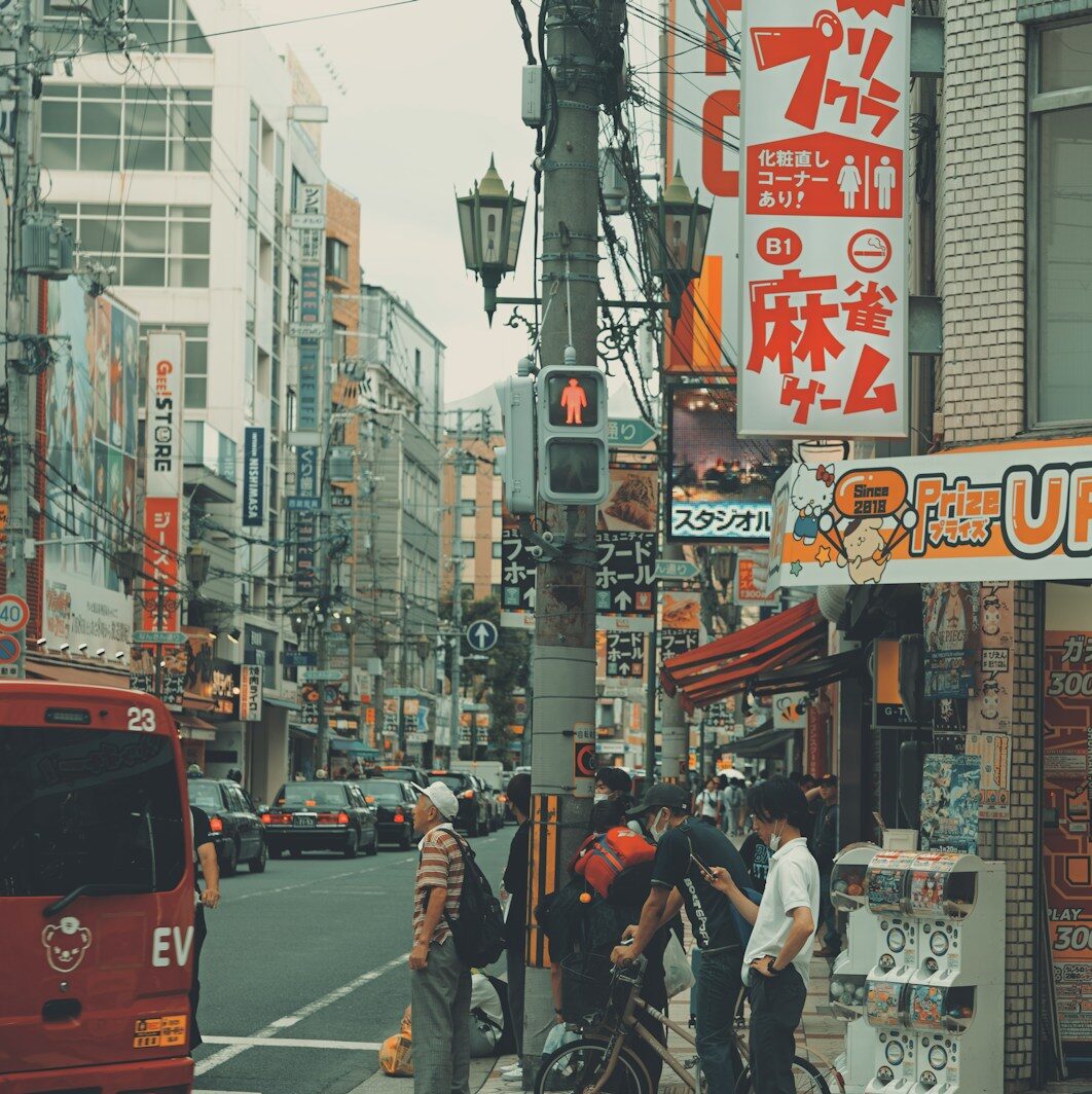 a group of people standing on the side of a street